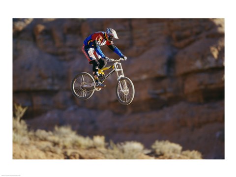 Framed Side profile of a person on a bicycle in mid air Print