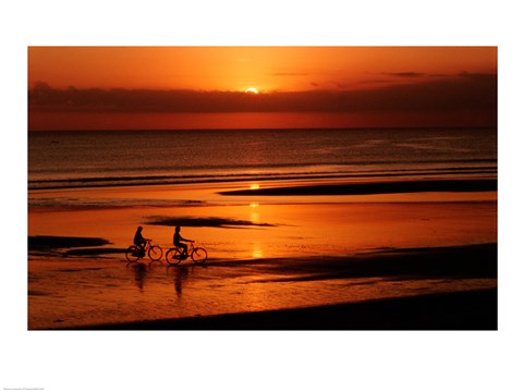 Framed Silhouette of a young couple cycling on the beach Print