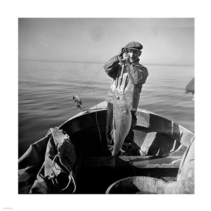 Framed Hauling in a cod aboard a Portuguese fishing dory off Cape Cod, Massachusetts Print