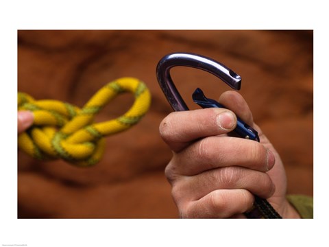 Framed Close-up of human hands holding a carabiner and rope Print