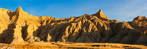 Framed Sculpted sandstone spires in golden light, Saddle Pass Trail, Badlands National Park, South Dakota, USA Print