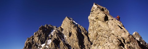 Framed Low angle view of a man climbing up a mountain, Rockchuck Peak, Grand Teton National Park, Wyoming, USA Print