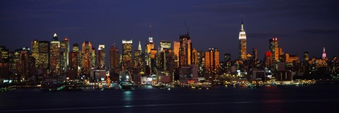 Framed Skyscrapers lit up at night in a city, Manhattan, New York City, New York State, USA Print