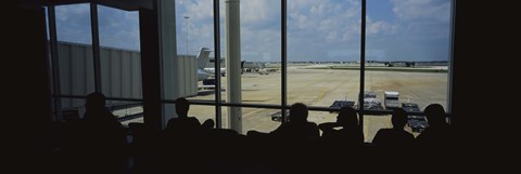 Framed Silhouette of a group of people at an airport lounge, Orlando International Airport, Orlando, Florida, USA Print