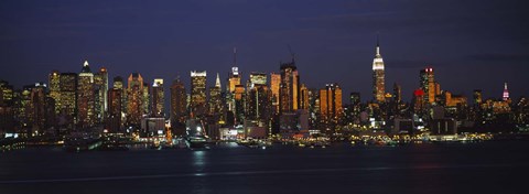 Framed Skyscrapers lit up at night in a city, Manhattan, New York City, New York State, USA Print