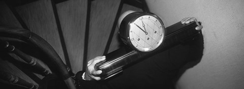 Framed Man Carrying Clock Up Stairs On Shoulders Print
