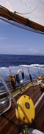 Framed Detail of the mainsheet block of a wooden sailboat in the sea Print