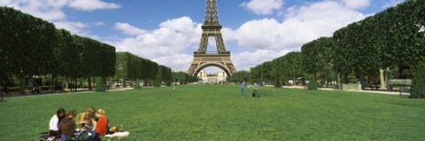 Framed Tourists sitting in a park with a tower in the background, Eiffel Tower, Paris, Ile-de-France, France Print