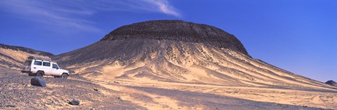 Framed SUV moving in a desert, Black Desert, Bahariya Oasis, Egypt Print