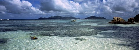 Framed Snorkeler in the clean waters on Anse Source d&#39;Argent beach, La Digue Island, Seychelles Print
