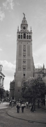 Framed Group of people walking near a church, La Giralda, Seville Cathedral, Seville, Seville Province, Andalusia, Spain Print