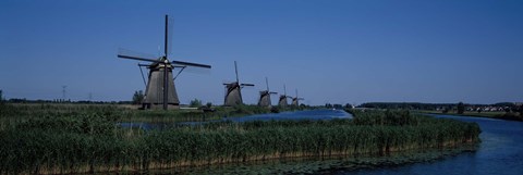Framed Traditional windmills at a riverbank, Kinderdijk, Rotterdam, Netherlands Print