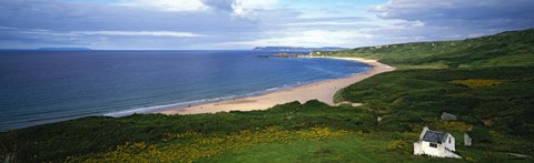 Framed Birds-eye view of sea, white stone cottage, Northern Ireland. Print
