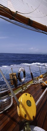 Framed Detail of the mainsheet block of a wooden sailboat in the sea Print
