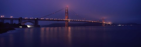 Framed Suspension bridge lit up at dawn viewed from fishing pier, Golden Gate Bridge, San Francisco Bay, San Francisco, California, USA Print