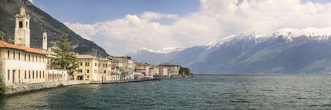 Framed Buildings at the waterfront with snowcapped mountain in the background, Gargnano, Monte Baldo, Lake Garda, Lombardy, Italy Print
