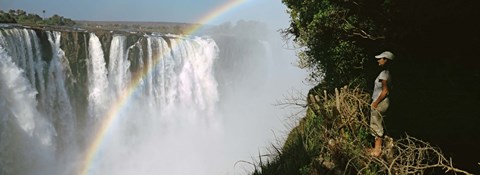 Framed Woman looking at a rainbow over the Victoria Falls, Zimbabwe Print