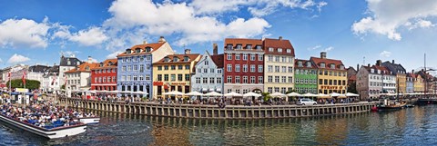 Framed Tourists in a tourboat with buildings along a canal, Nyhavn, Copenhagen, Denmark Print