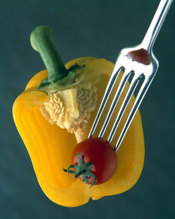 Framed Close up of half yellow pepper with cherry tomato in center on fork tines Print