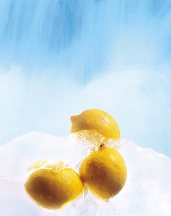 Framed Three lemons frozen in ice below ice blue sky Print