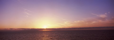 Framed Sun Setting Behind Clouds over the Sea Print