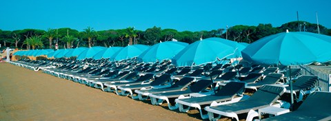 Framed Parasols with lounge chairs on a private beach in summer morning light, French Riviera, France Print