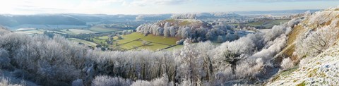 Framed Snow covered trees in a valley from Uley Bury, Downham Hill, Gloucestershire, England Print