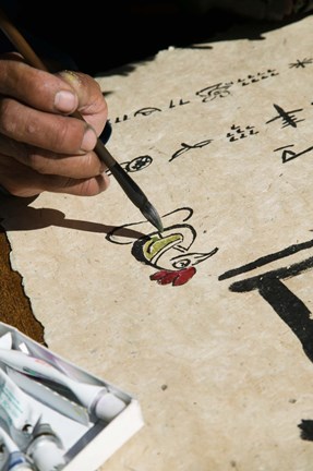 Framed Chinese calligrapher painting calligraphy on a paper at the Dongba Place, Old Town, Lijiang, Yunnan Province, China Print