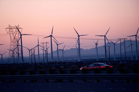 Framed Car moving on a road with wind turbines in background at dusk, Palm Springs, Riverside County, California, USA Print