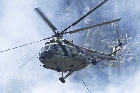 Framed Bulgarian Air Force Mi-17 helicopter over a forest fire in Bulgaria Print