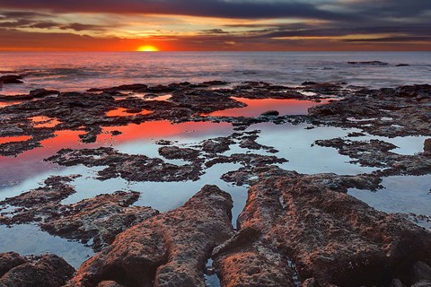 Framed Tidal pools reflect the sunrise colors during the autumn equinox Print