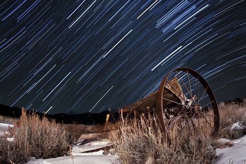 Framed Abandoned farm equipment against a backdrop of star trails Print