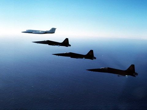 Framed Three F-5E Tiger IIs fly in formation with a Learjet 25 Print