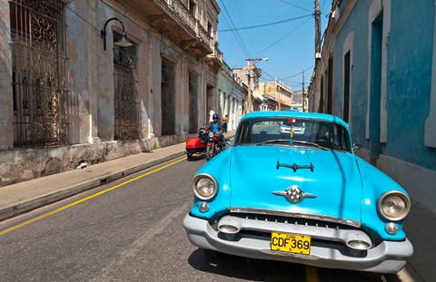 Framed Cuba, Camaquey, Oldsmobile car and buildings Print