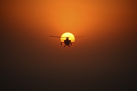 Framed AH-64D Apache Helicopter Flying into the Sun over Iraq Print