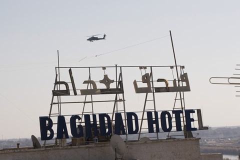 Framed AH-64 Apache in flight over the Baghdad Hotel in central Baghdad, Iraq Print