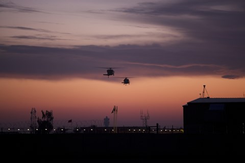 Framed pair of UH-60 Black Hawk helicopters approach their Landing in Baghdad, Iraq Print