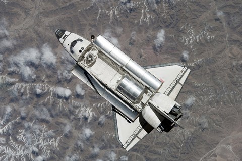 Framed Aerial view of Space Shuttle Discovery over Earth as it approaches the International Space Station Print