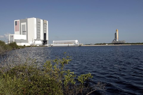 Framed Viewed across the Basin, Space Shuttle Atlantis Crawls Toward the Launch Pad Print