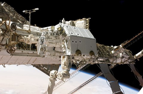 Framed Canadian-Built Dextre Robotic System in the Grasp of the Robotic Canadarm2 Print