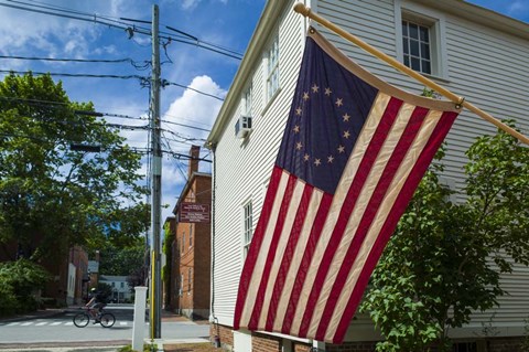 Framed New Hampshire, Portsmouth, Strawberry Banke Historic Area, building with US flag Print