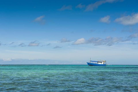 Framed Fishing boat in the turquoise waters of the blue lagoon, Yasawa, Fiji, South Pacific Print