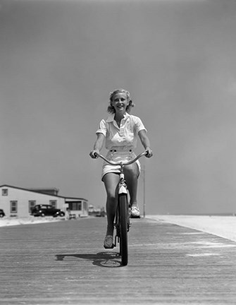 Framed 1940s Summer Time Smiling Woman Riding Bike On Beach Boardwalk Print