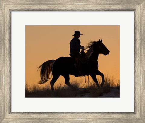 Framed Cowboy Riding His Horse Winters Snow Silhouetted At Sunset Print