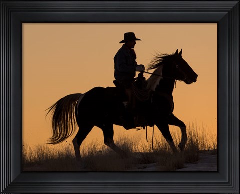 Framed Cowboy Riding His Horse Winters Snow Silhouetted At Sunset Print