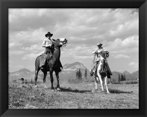 Framed Pair Of Cowboys On Horseback At Glacier Fifty Mountain Camp Print