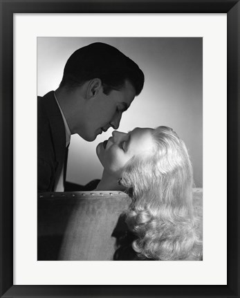 Framed Movie Star Studio Style Romantic Couple Embracing On Sofa About To Kiss Print