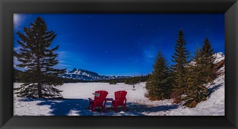 Framed Red Chairs Under a Moonlit Winter Sky at Two Jack Lake Print