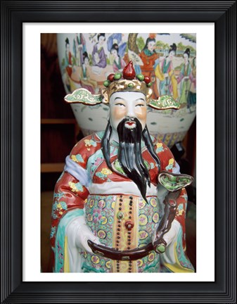 Framed Statue of a snake charmer holding a snake Print