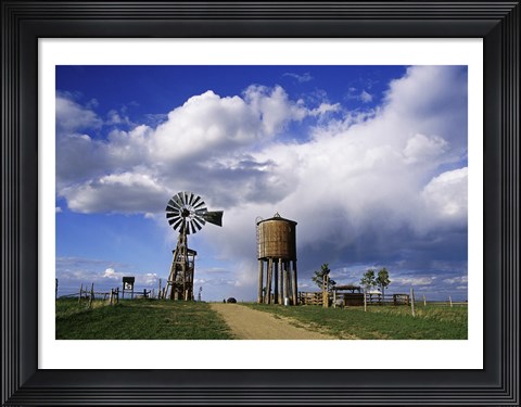 Framed Low angle view of a water tower and an industrial windmill, 1880 Town, South Dakota, USA Print